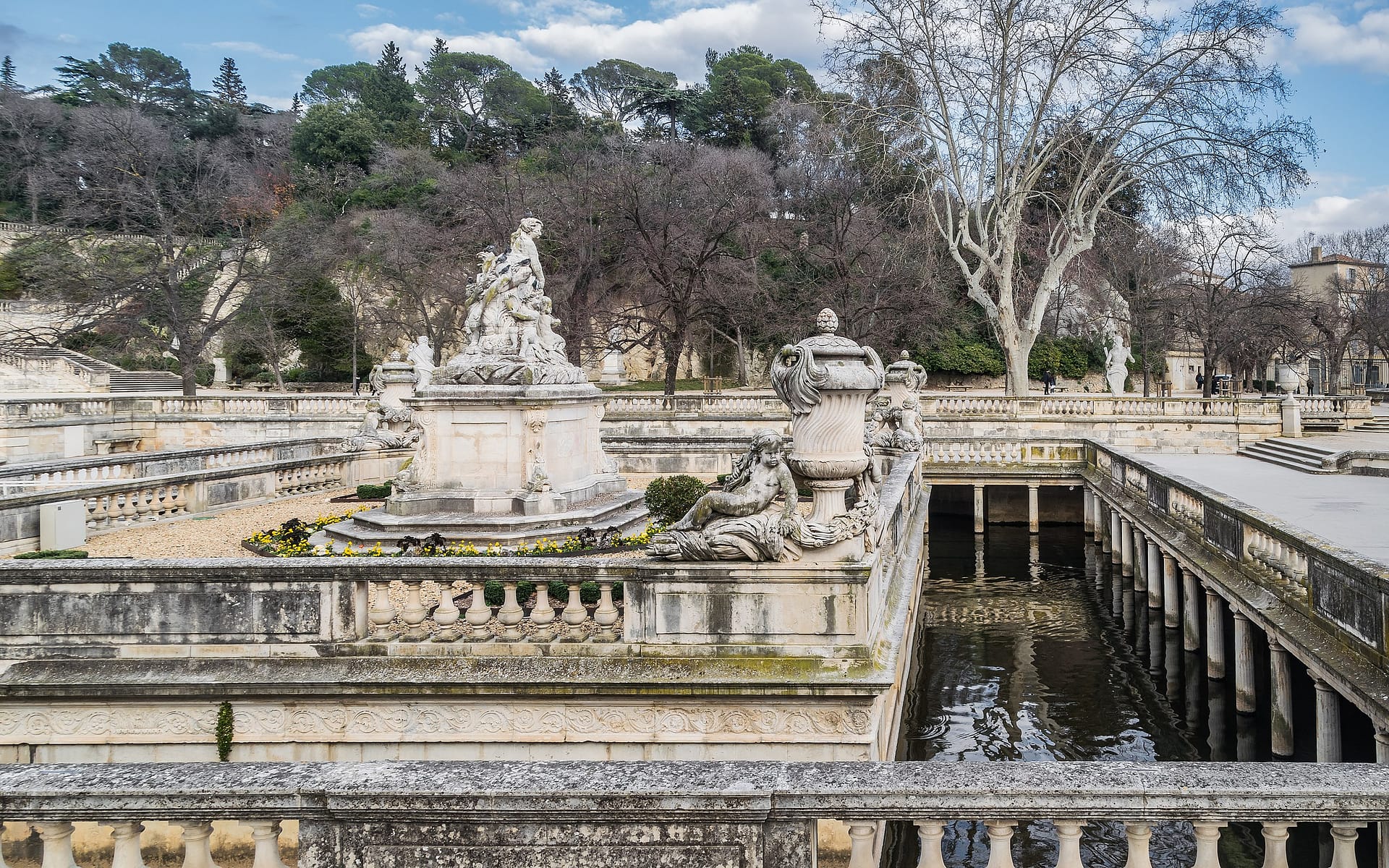 Jardins de la Fontaine à Nîmes avec bassin, statues et végétation méditerranéenne